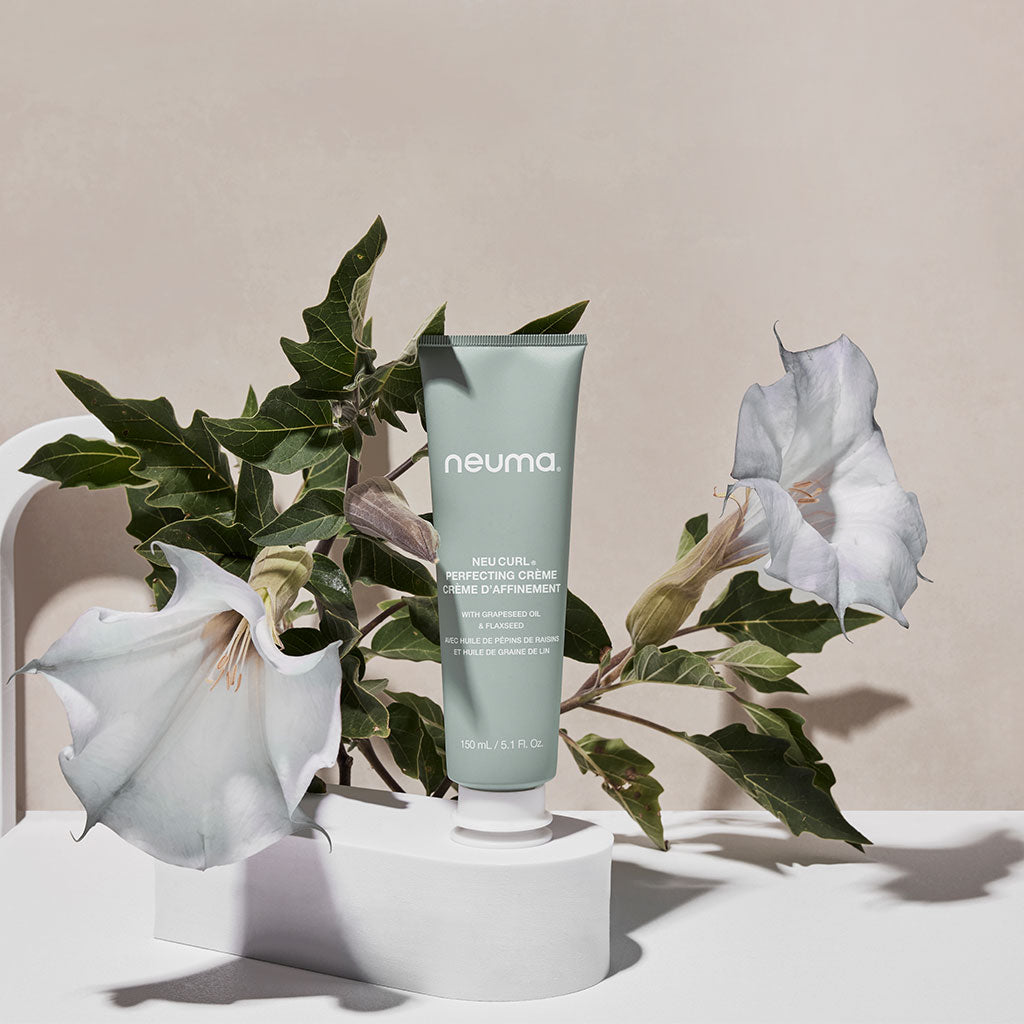Neu Curl Perfecting Crème with hibiscus aroma for enhancing curls, providing frizz-free finish, shape, and hydration support.