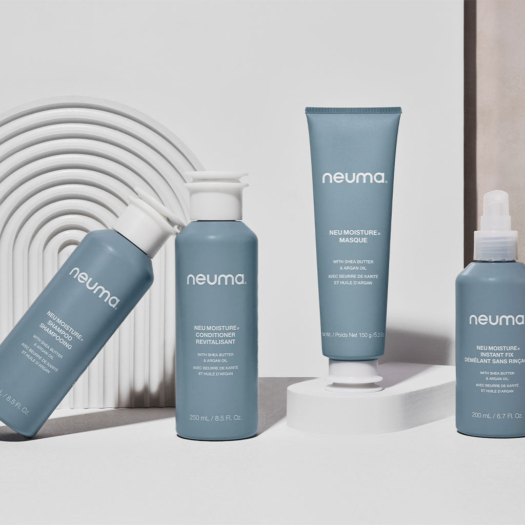 Collection of Neuma Neu Moisture products including the hydrating masque, conditioner, and treatment bottles on display.