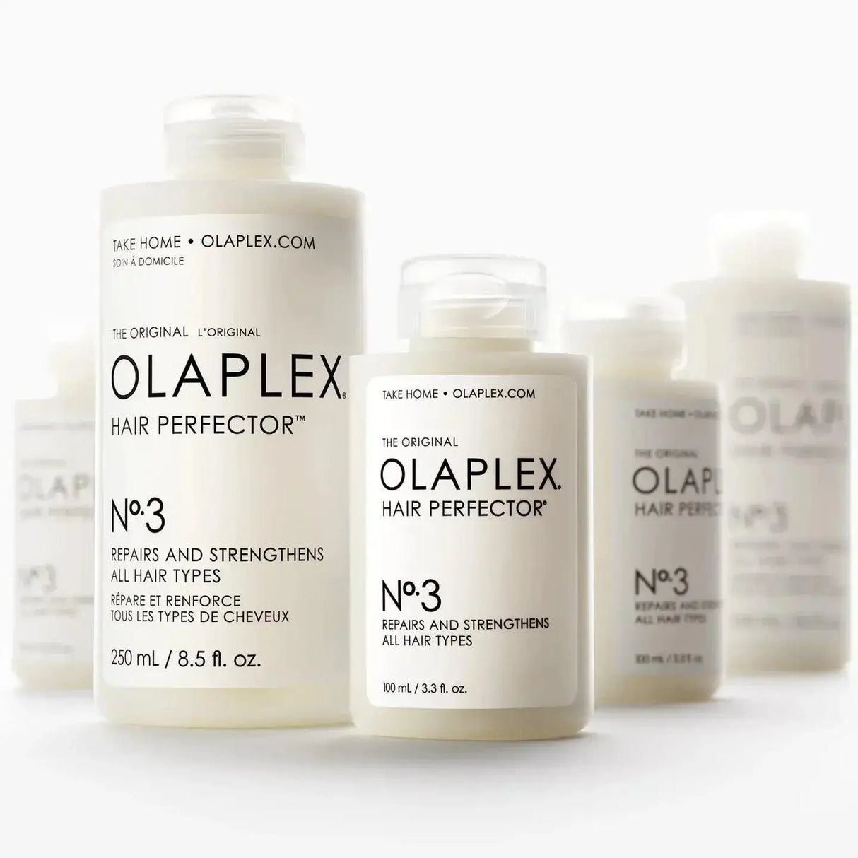 Bottles of Olaplex No.3 Hair Perfector, a treatment for strengthening and repairing damaged hair, suitable for all hair types.