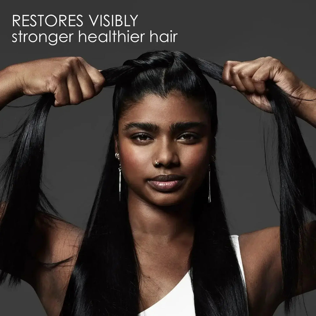 Woman with long, healthy hair showcasing the effects of Olaplex No.3 Hair Perfector, emphasizing restored strength and health.