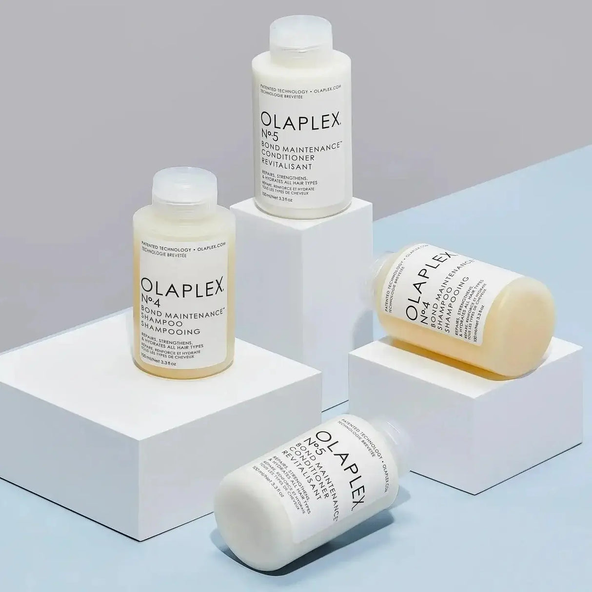 Olaplex Nº.4 Bond Maintenance Shampoo and Conditioner bottles on display blocks, designed for repairing and hydrating damaged hair.