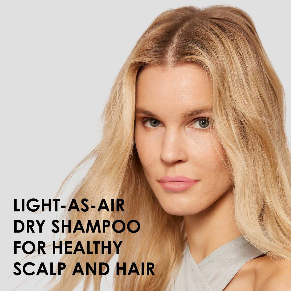Woman with healthy hair using Olaplex Nº.4D Clean Volume Detox Dry Shampoo for all hair types and textures, enhances volume.