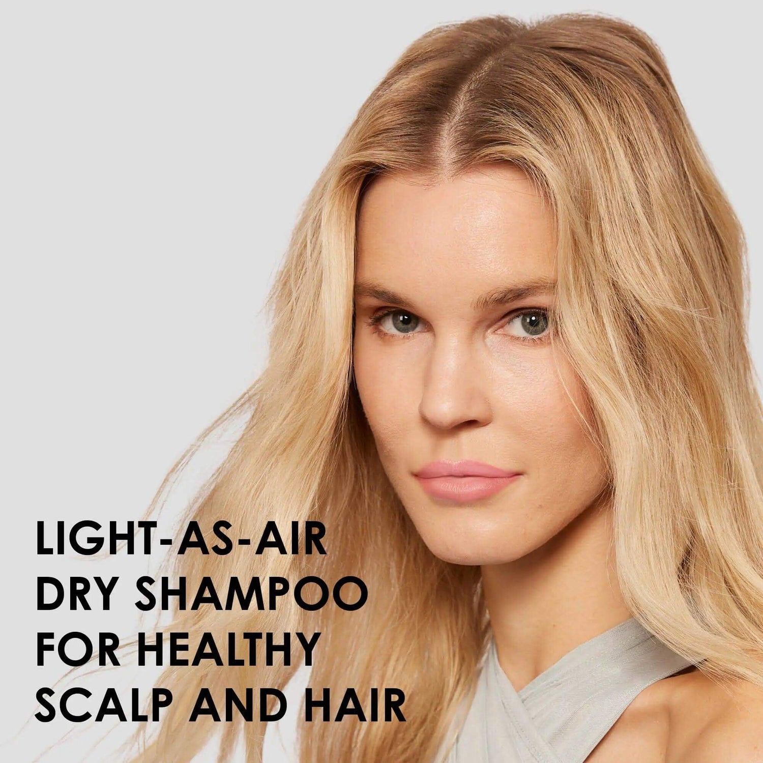 Woman with healthy hair using Olaplex Nº.4D Clean Volume Detox Dry Shampoo for all hair types and textures, enhances volume.
