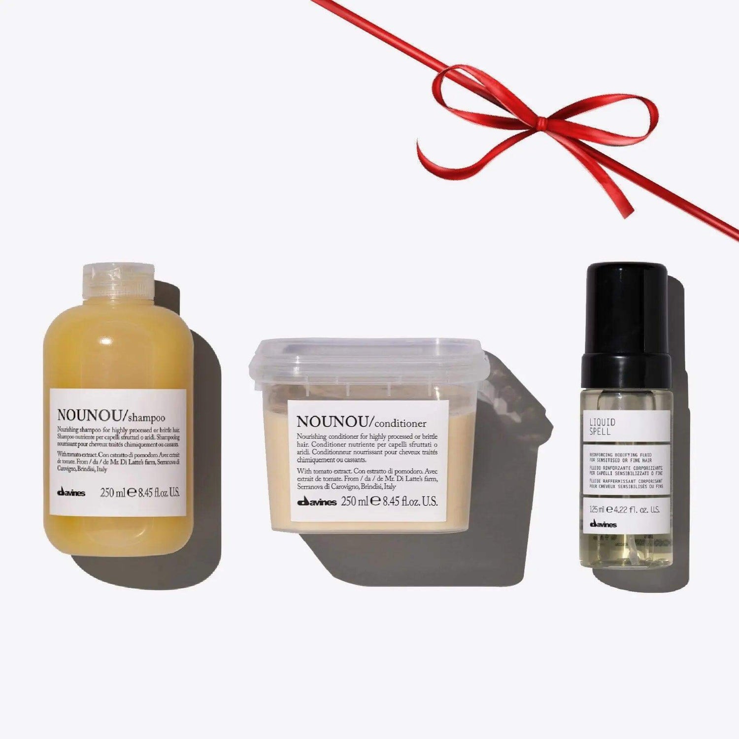 NOUNOU + Liquid Spell Set for nourishing and restoring damaged hair, featuring shampoo, conditioner, and a liquid spell treatment with ribbon.