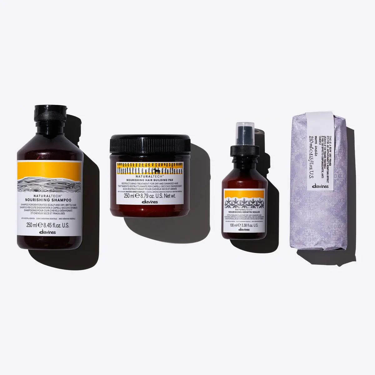 Davines Nourished Blowout Set including shampoo, conditioner, serum, and bar soap on a white background.