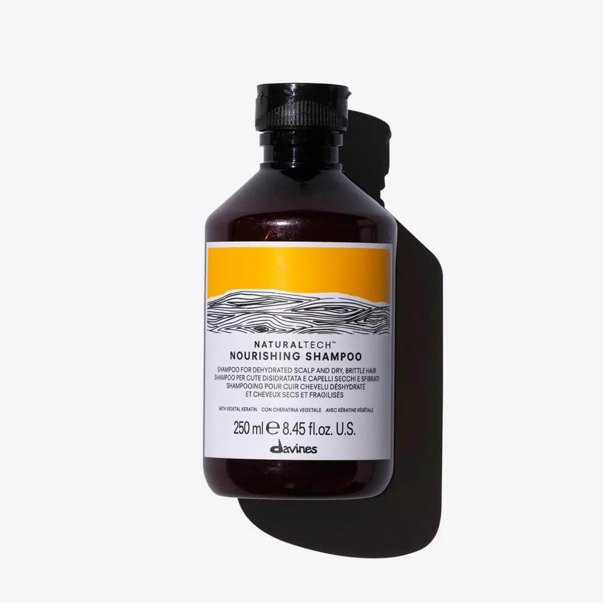 Bottle of Nourishing Shampoo for dehydrated scalp and brittle hair, providing gentle cleansing and nourishment.