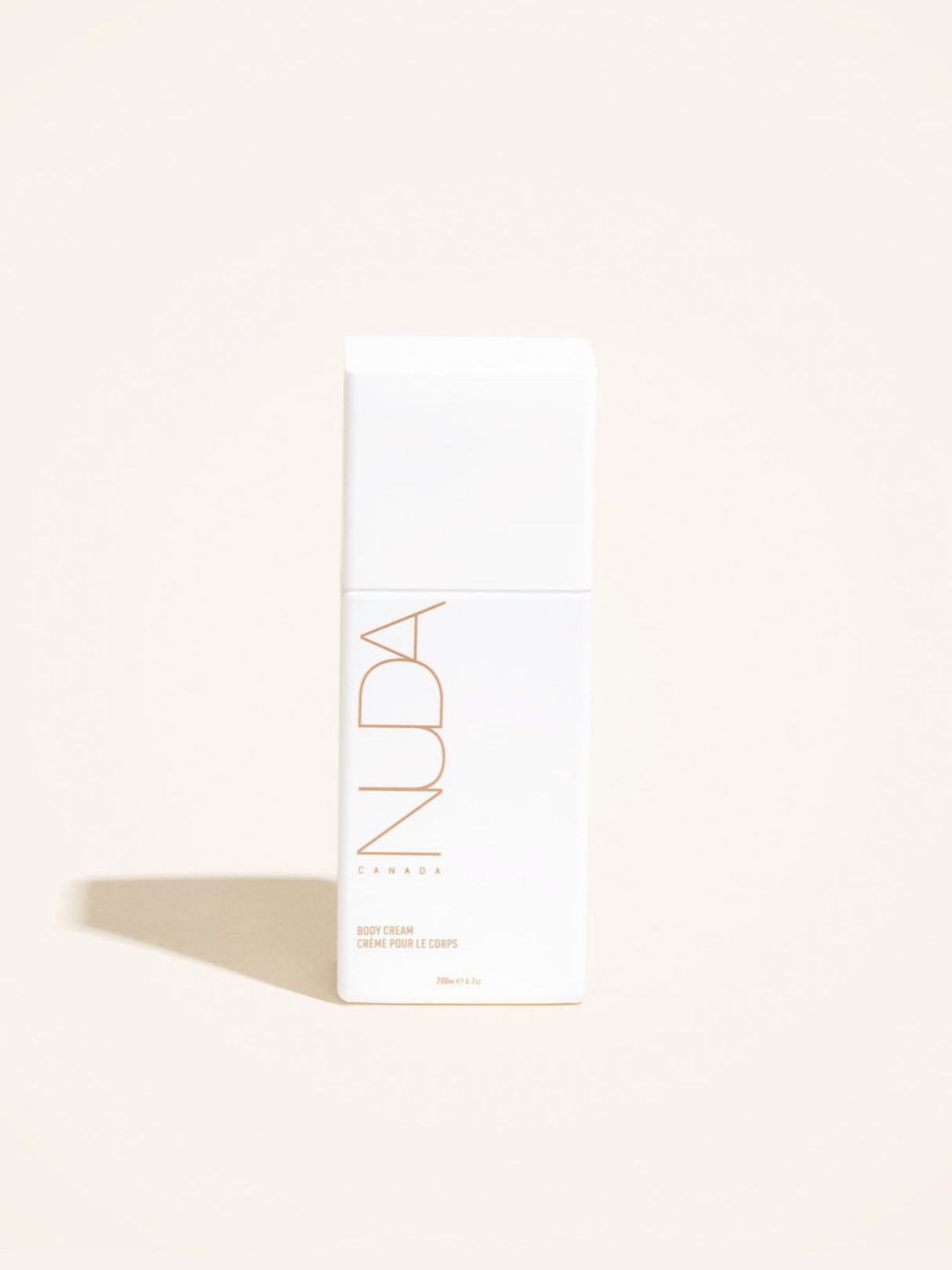 Luxurious body cream with shea butter, avocado oil, and aloe vera for rich hydration and silky smooth skin in an elegant white bottle.
