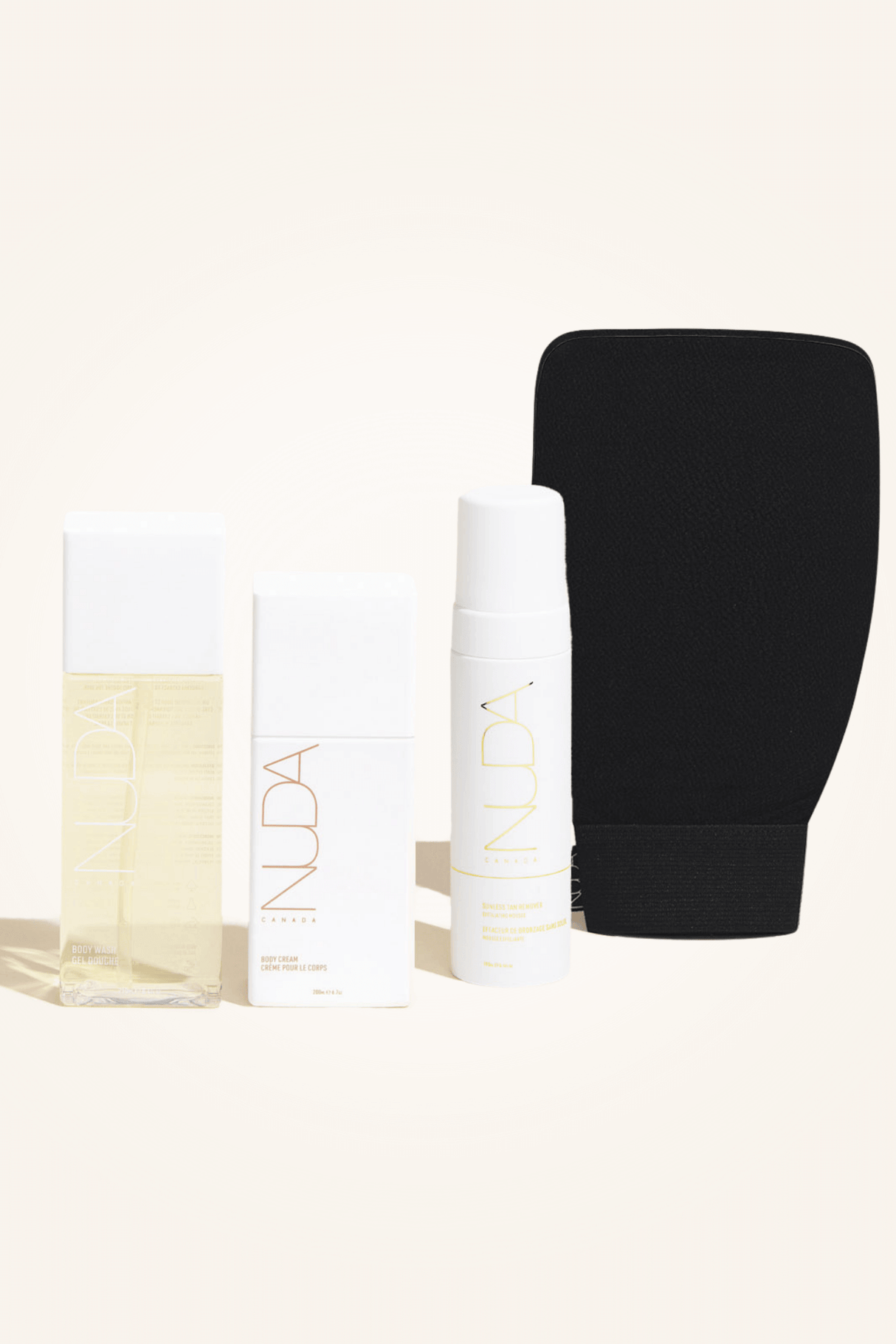 Body Essentials Kit featuring body exfoliant, tan remover, exfoliating mitt, and hydrating body cream for sunless tanning preparation.