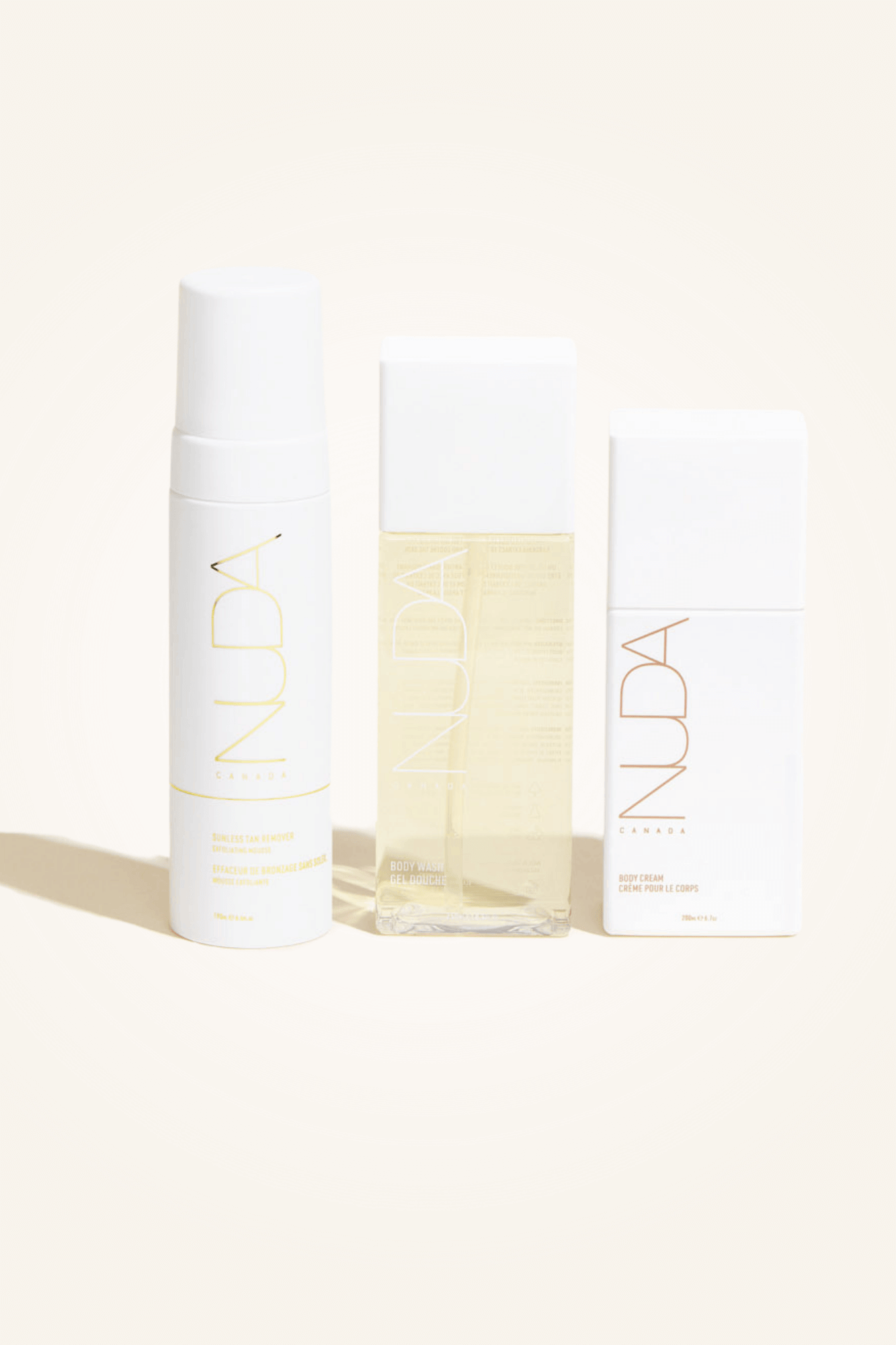 Body Essentials Trio set with exfoliant, body wash, and cream for sunless tanning preparation and skin hydration.