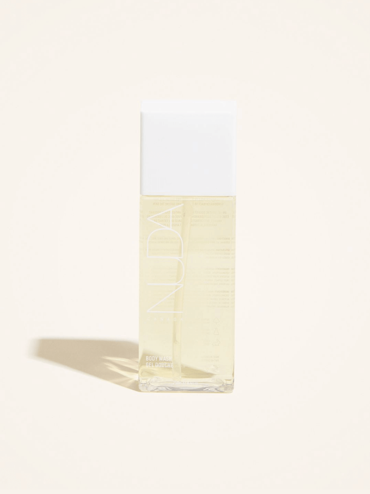 Gentle body wash ideal for sunless tanning aftercare, infused with antioxidants, vanilla, and lemon extract in a clear bottle.