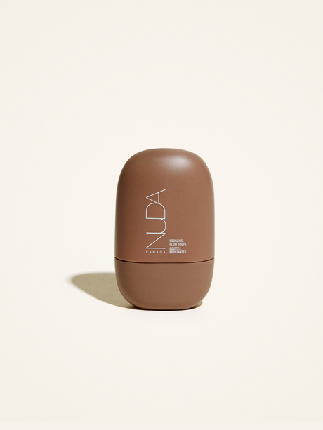 Nuda Bronzing Glow Drops bottle for a radiant, sun-kissed look with hydrating glycerin and squalane, vegan-friendly formula.