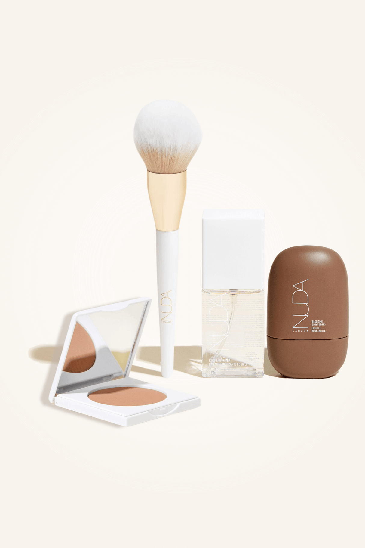 Deluxe Bronzed Kit featuring a facial self tanner, matte bronzing powder, brush, and bronzing glow drops for a radiant finish.