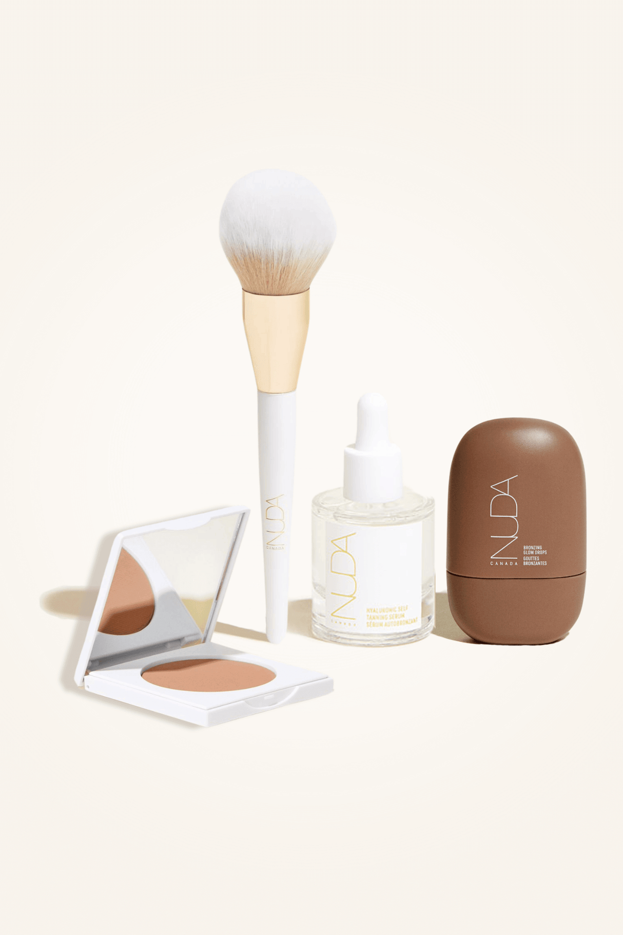 Deluxe Bronzed Kit with facial self tanner, matte bronzing powder, bronzing brush, and glow drops for a radiant look.
