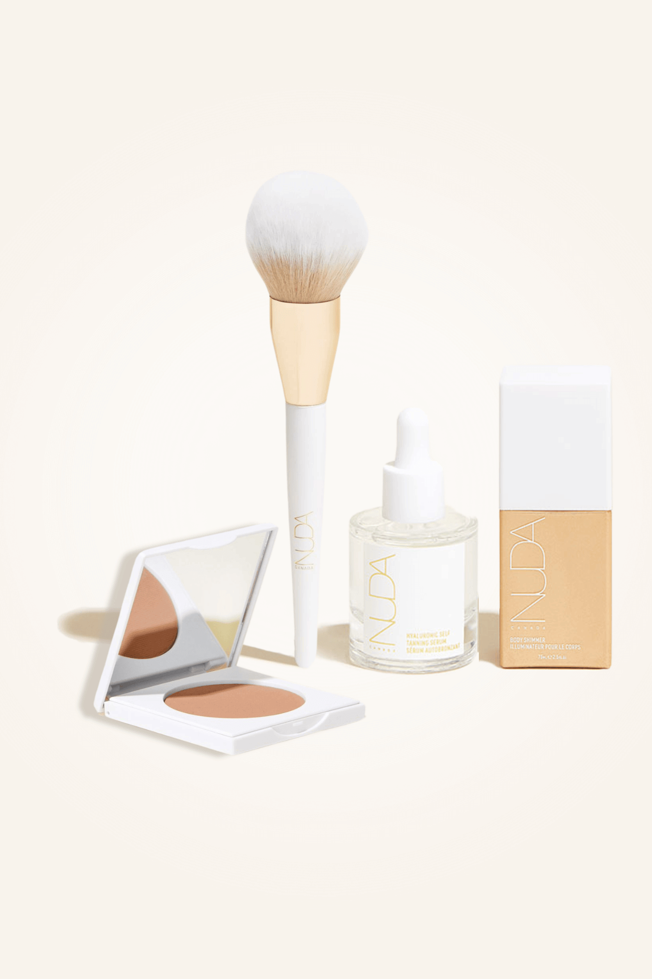 Deluxe Bronzed Trio featuring facial self tanner, matte bronzing powder with brush, and glow drops for radiant, bronzed skin.