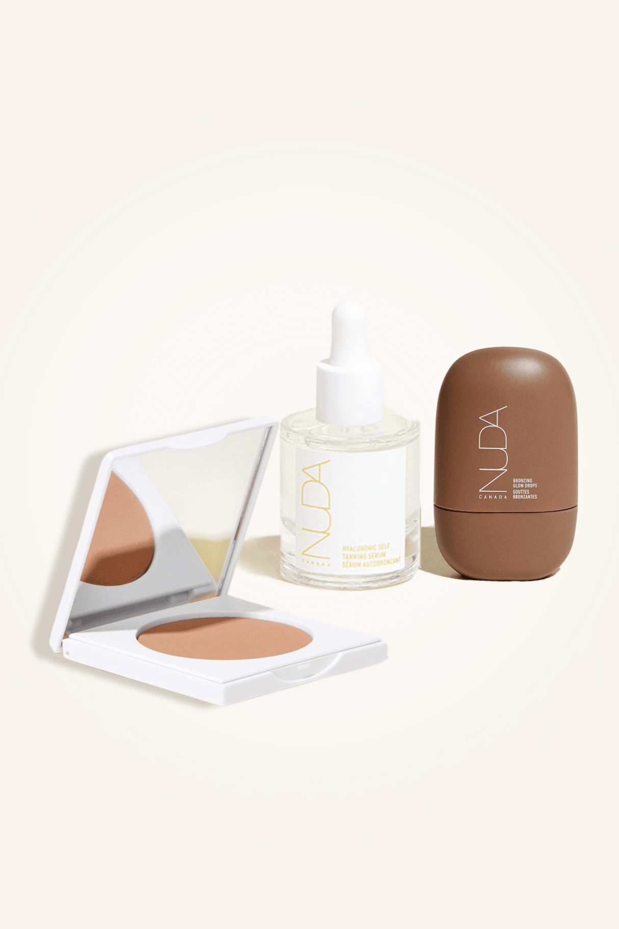 Deluxe Bronzed Trio featuring facial self tanner, matte bronzing powder with brush, and glow drops for radiant bronzed look.