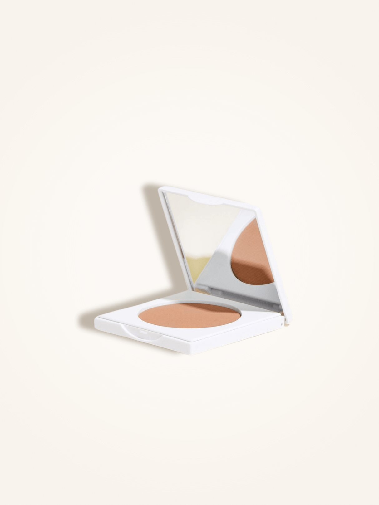 Open compact case of matte bronzing powder with mirror, designed for a natural tan and infused with jojoba, mango, and papaya extracts.