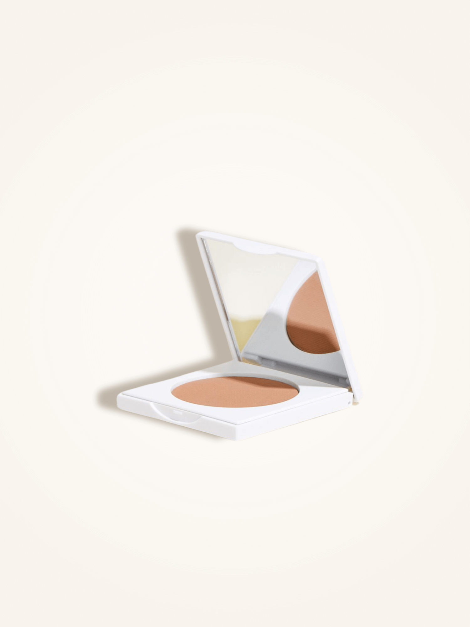 Open compact case of matte bronzing powder with mirror, designed for a natural tan and infused with jojoba, mango, and papaya extracts.