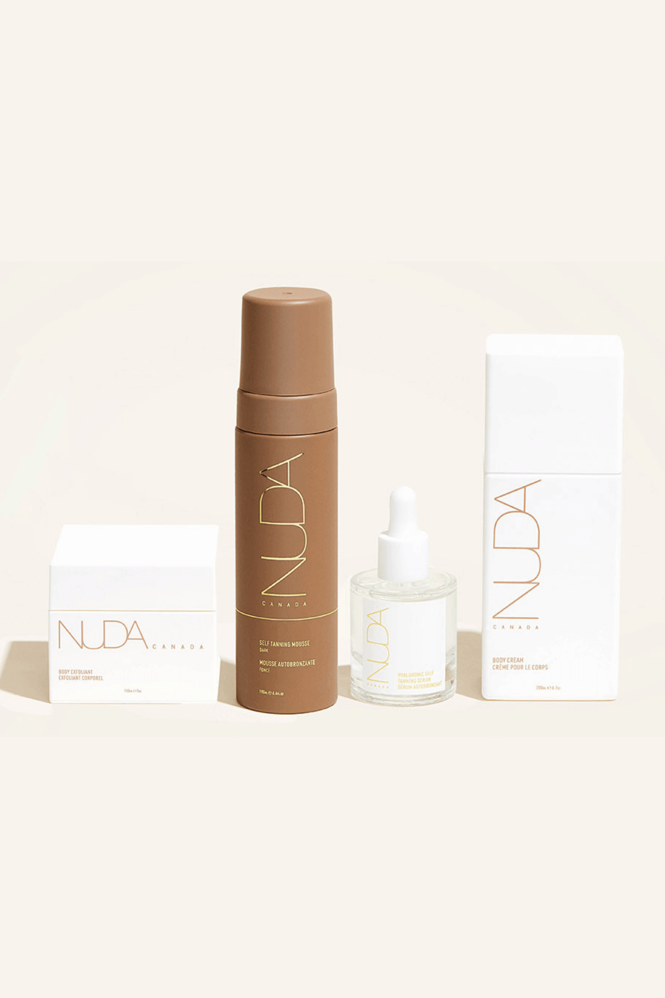 Nuda Routine Kit featuring body exfoliant, self tanning mousse, face tanner, and body cream for a radiant glow and prolonged tan.