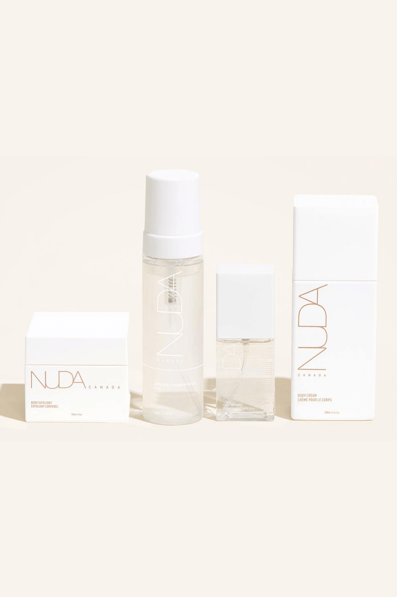 Nuda Routine Kit featuring body exfoliant, self tanning mousse, face tanner, and body cream for customized year-round tan.