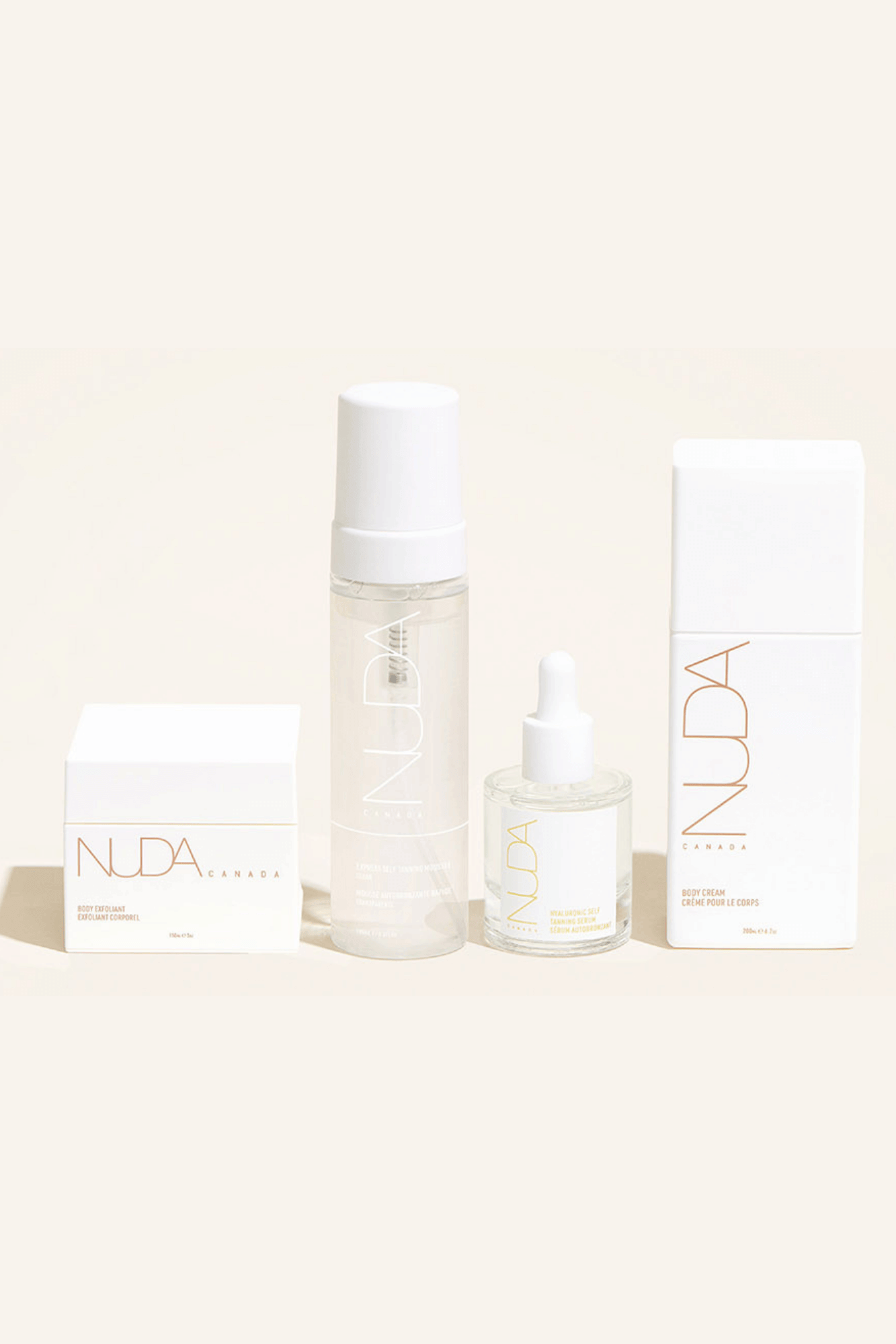 Nuda Routine Kit showcasing self tanning mousse, body exfoliant, face tanner, and body cream for a customized year-round tan.