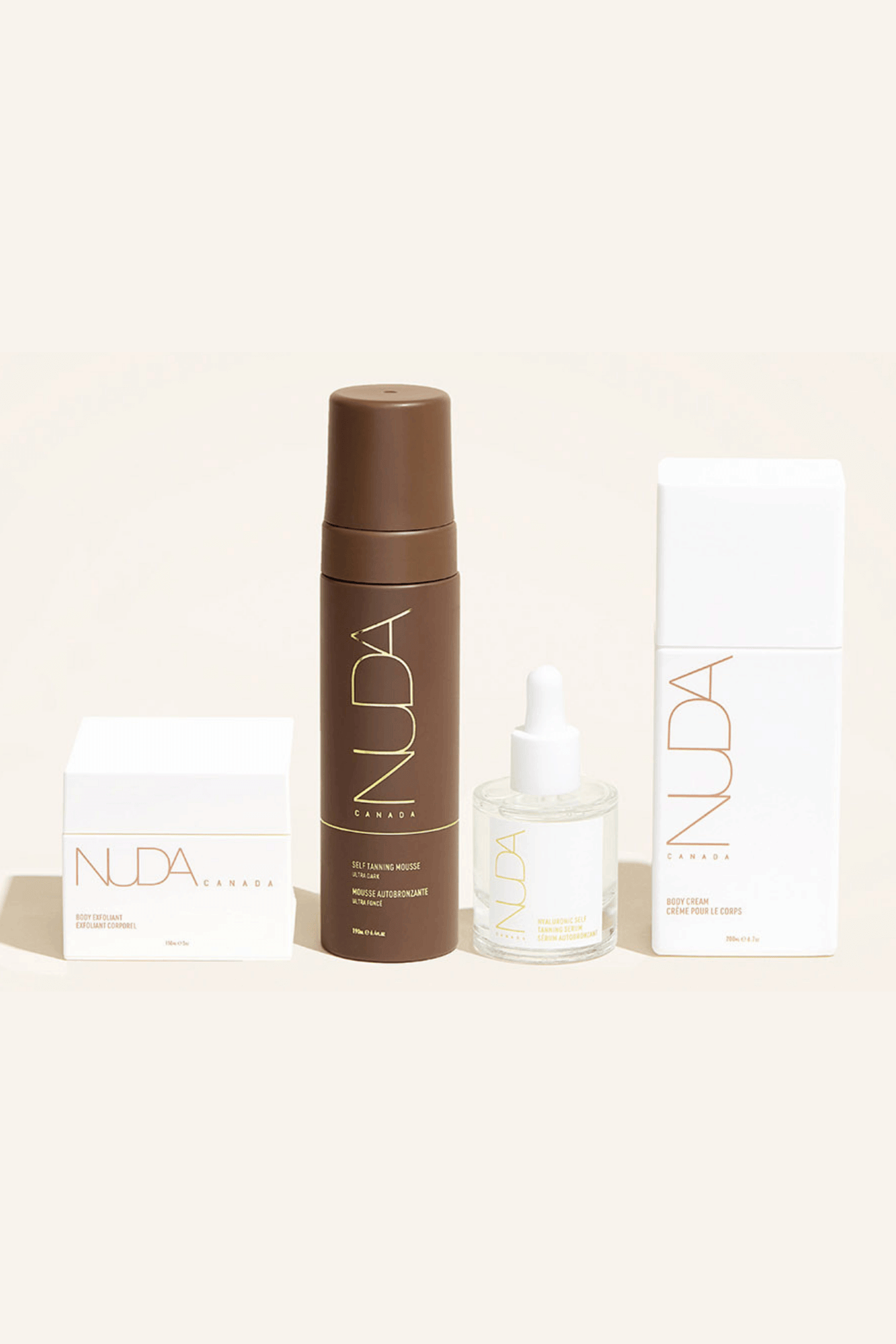 Nuda Routine Kit featuring body exfoliant, self tanning mousse, face tanner, and body cream for a customized year-round tan.