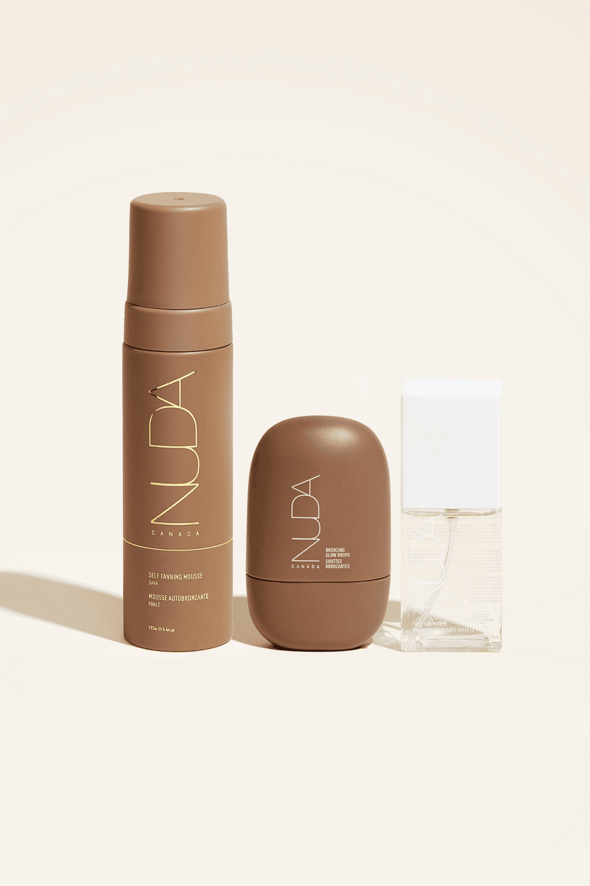 Ultimate Glow Trio self-tanning set including mousse, facial tanner, and bronzing drops for radiant and tailored skin glow.