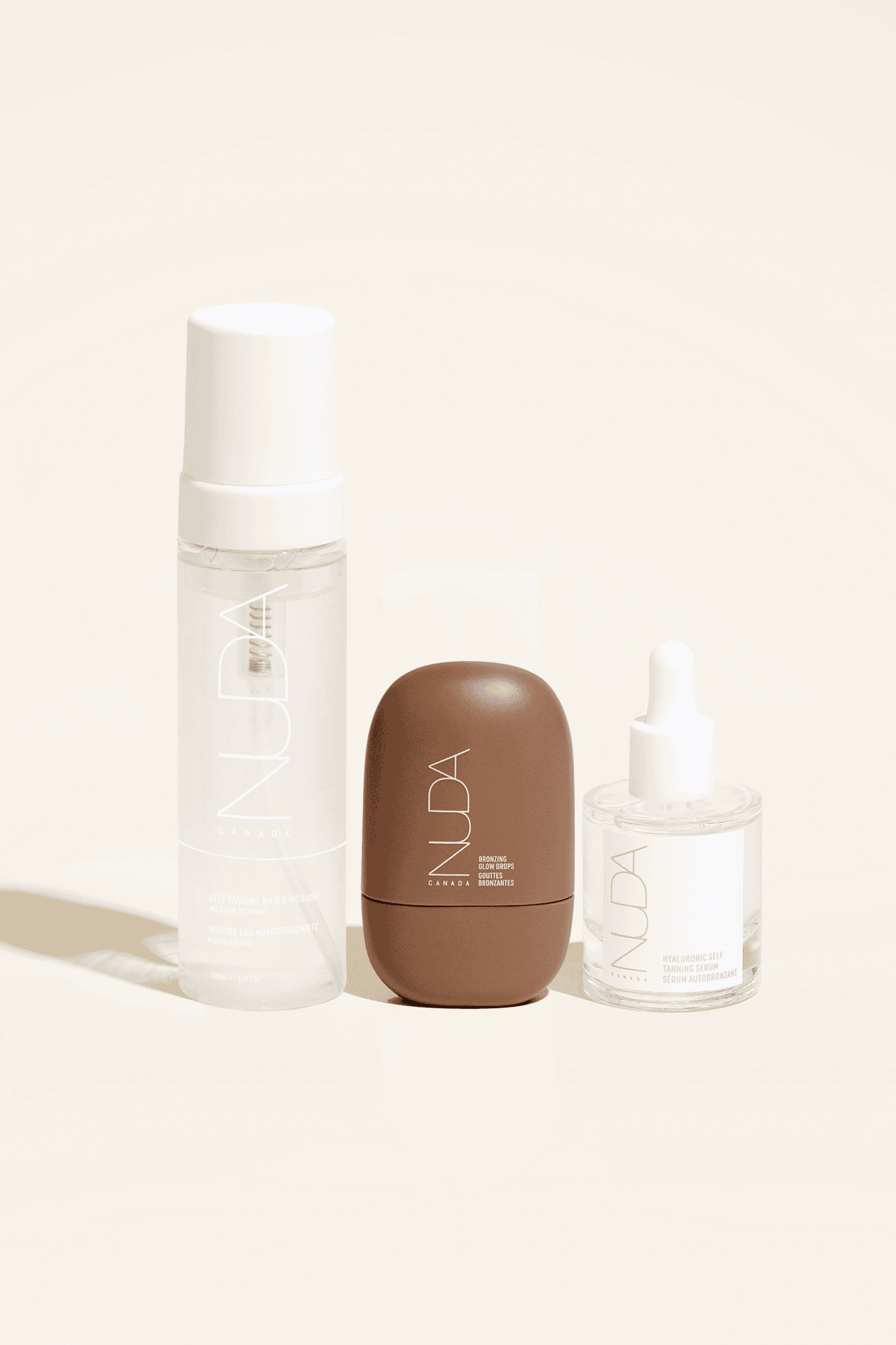 Ultimate Glow Trio self-tanning mousse, facial tanner, and shimmer drops for tailored radiant complexion and skin tone match.