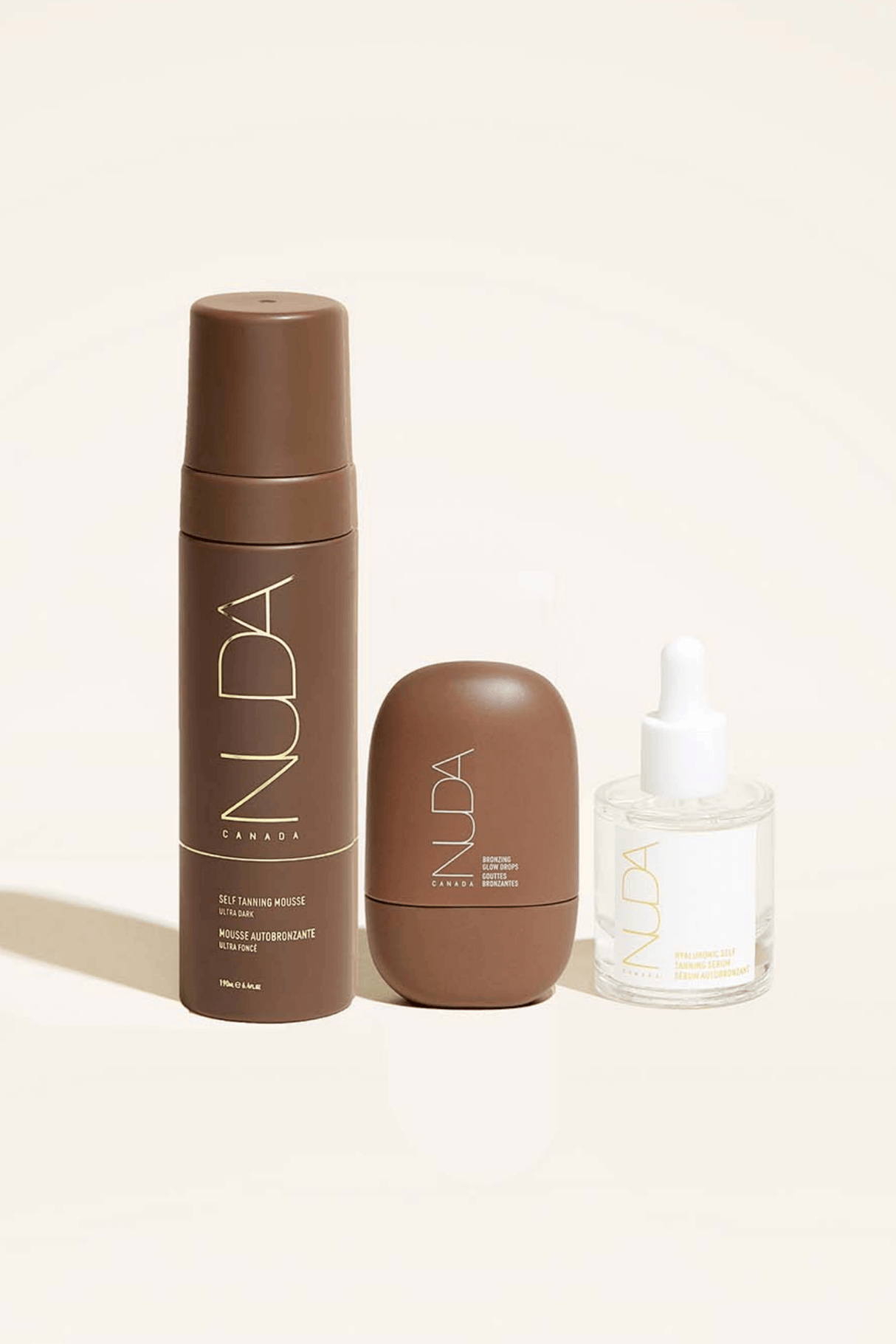 Ultimate Glow Trio set with self tanning mousse, facial tanner, and bronzing drops for customizable luminous skin.
