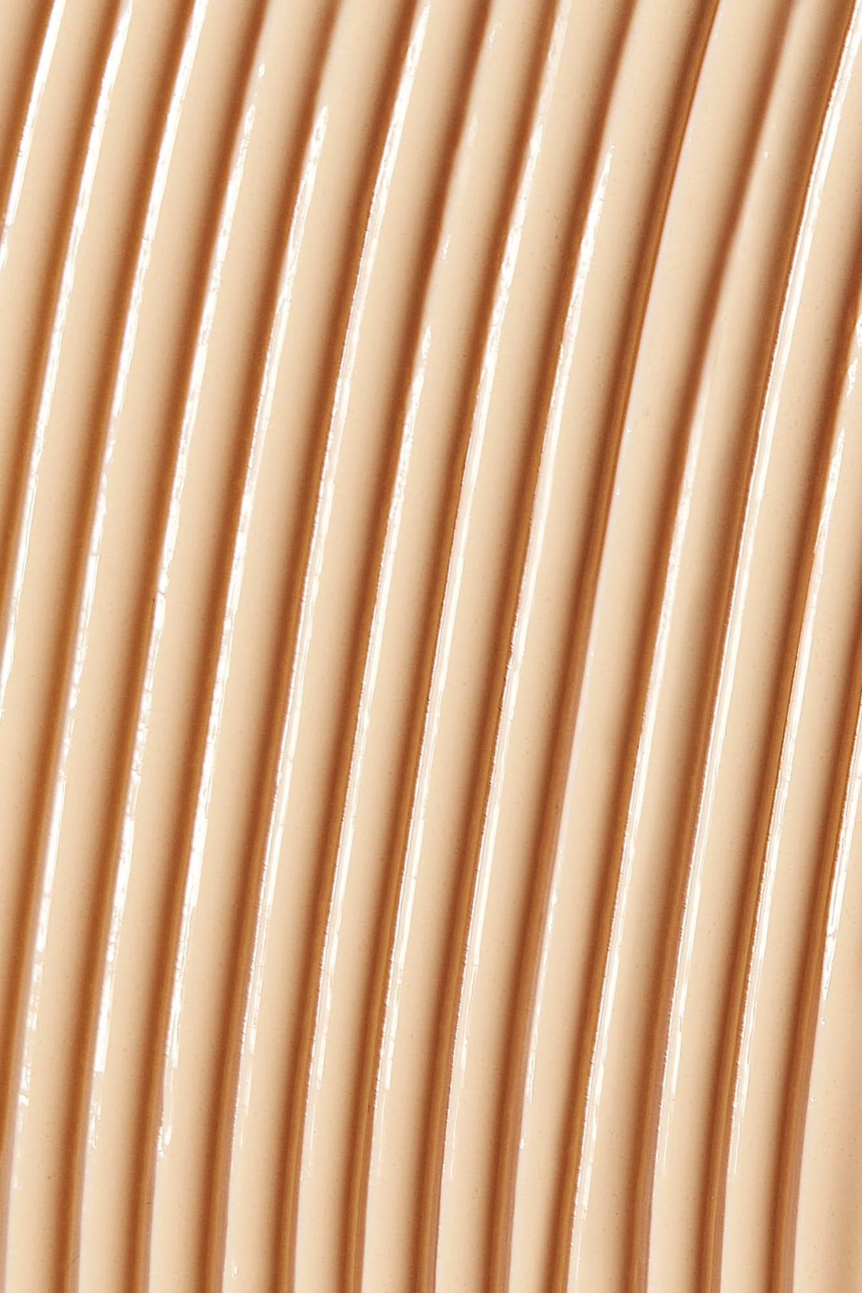 Close-up of Solarglow™ Mineral Serum Sunscreen SPF 30 texture showing smooth, creamy swirls for hydrating and sun-protective effect.