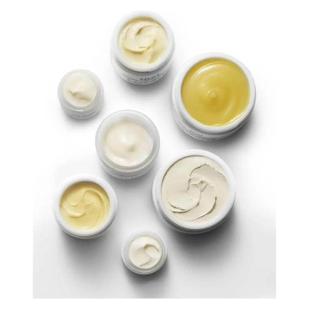 "Collection of open skincare jars showcasing various textures of Nuit Hydra Enzyme Masque."