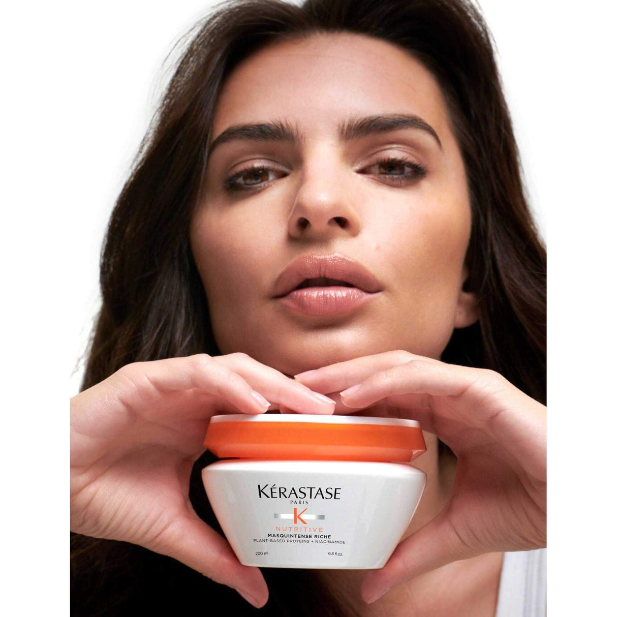 Woman holding Kérastase Nutritive Masquintense Riche for very dry hair