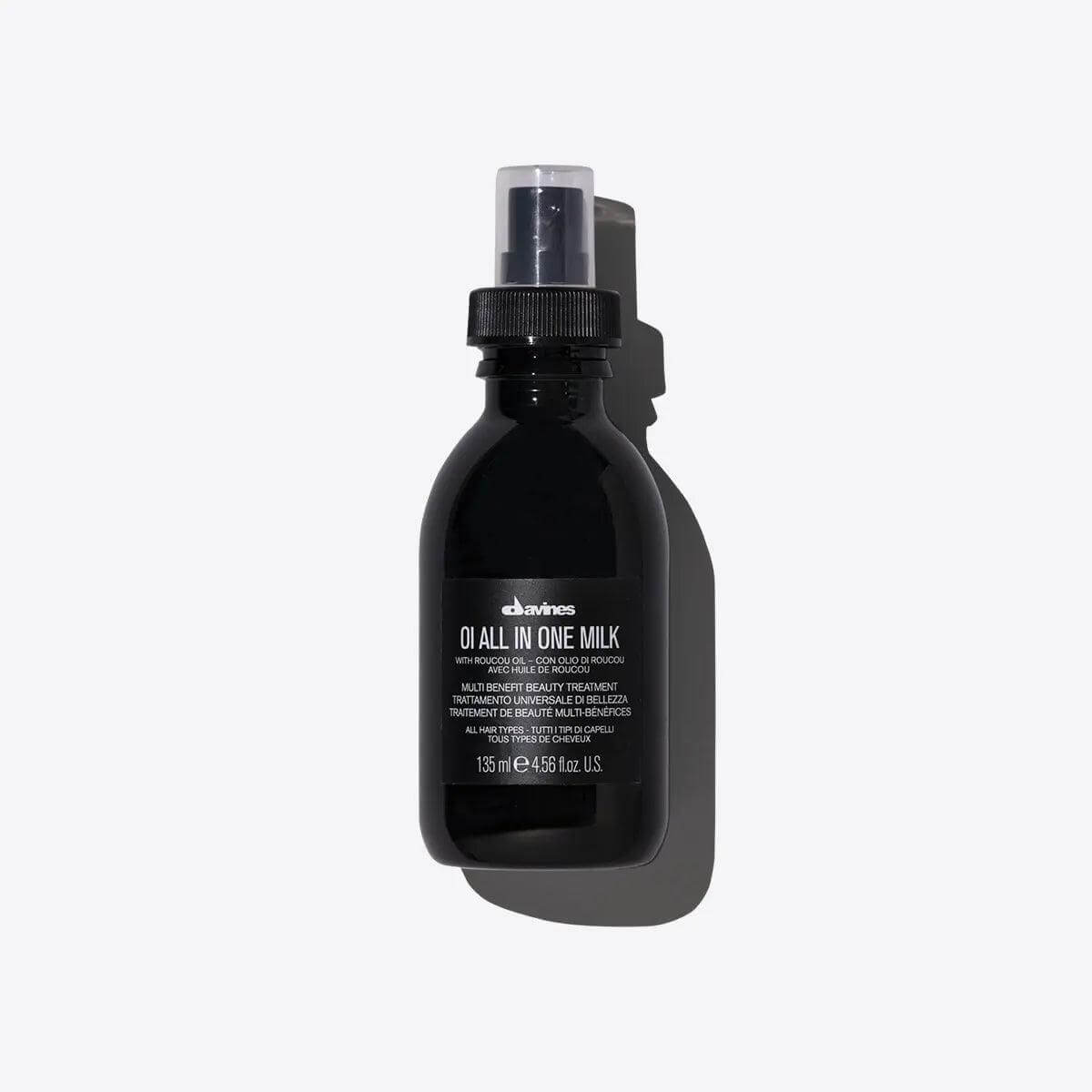 Oi All In One Milk spray bottle, multi-function hair treatment to soften, detangle, control frizz, and protect from heat.