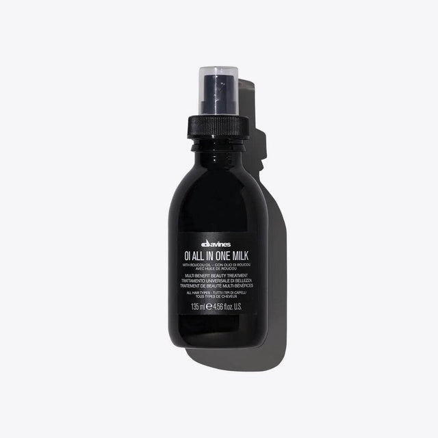 Oi All In One Milk spray bottle, multi-function hair treatment to soften, detangle, control frizz, and protect from heat.