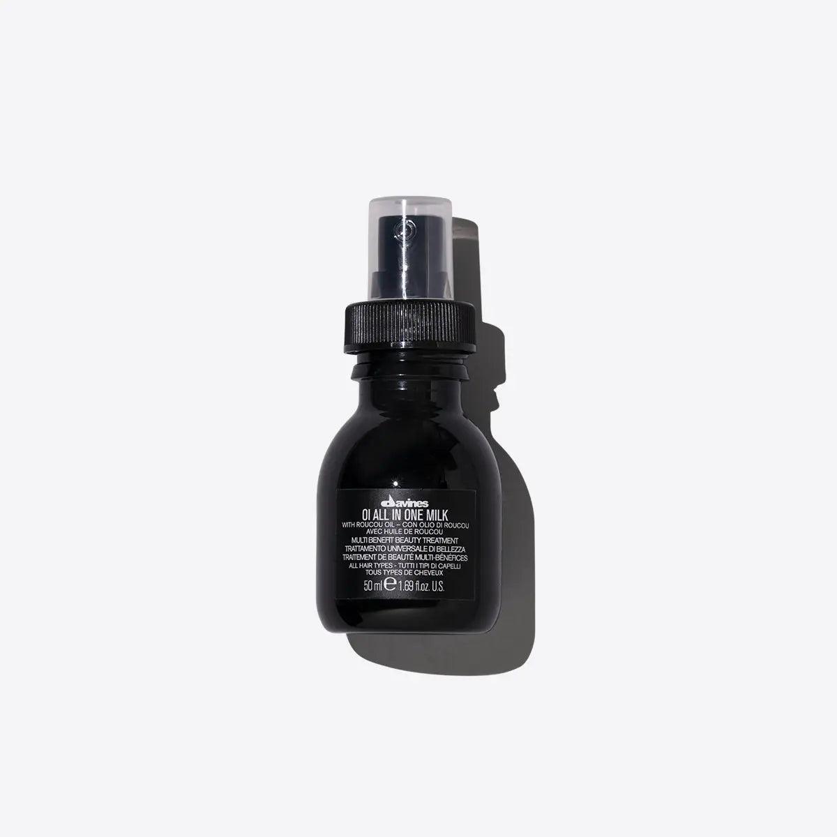 Oi All In One Milk leave-in spray bottle for softening, detangling, frizz control, and heat protection.