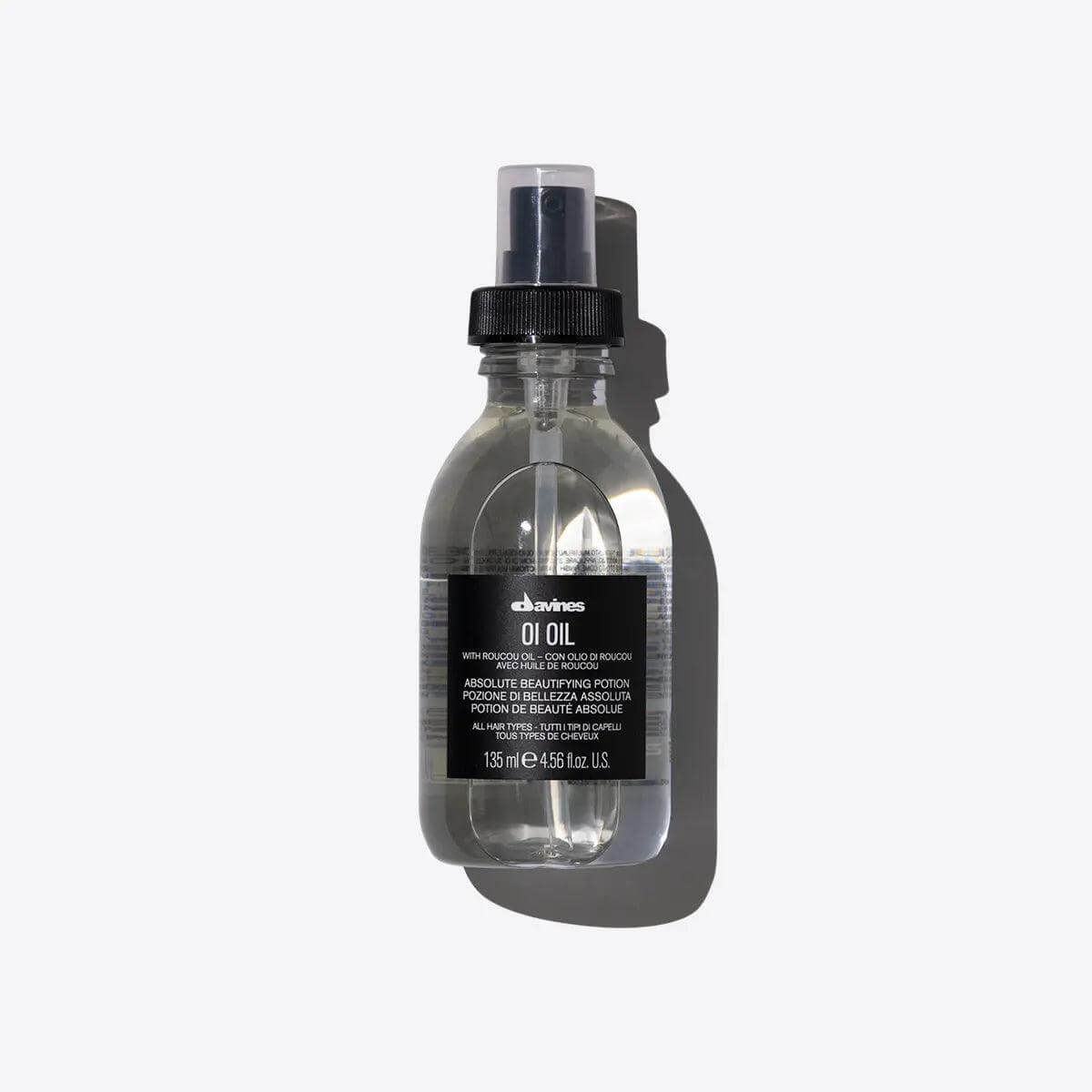 Davines Oi Oil bottle for enhancing hair shine and reducing frizz, ideal for coarse or dry hair, 135ml in a spray bottle.