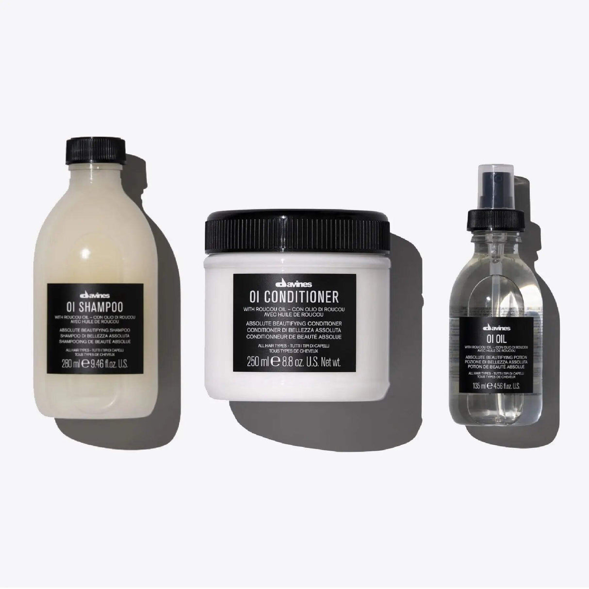 Oi Set featuring shampoo, conditioner, and oil for shiny, aromatic hair suitable for all types.
