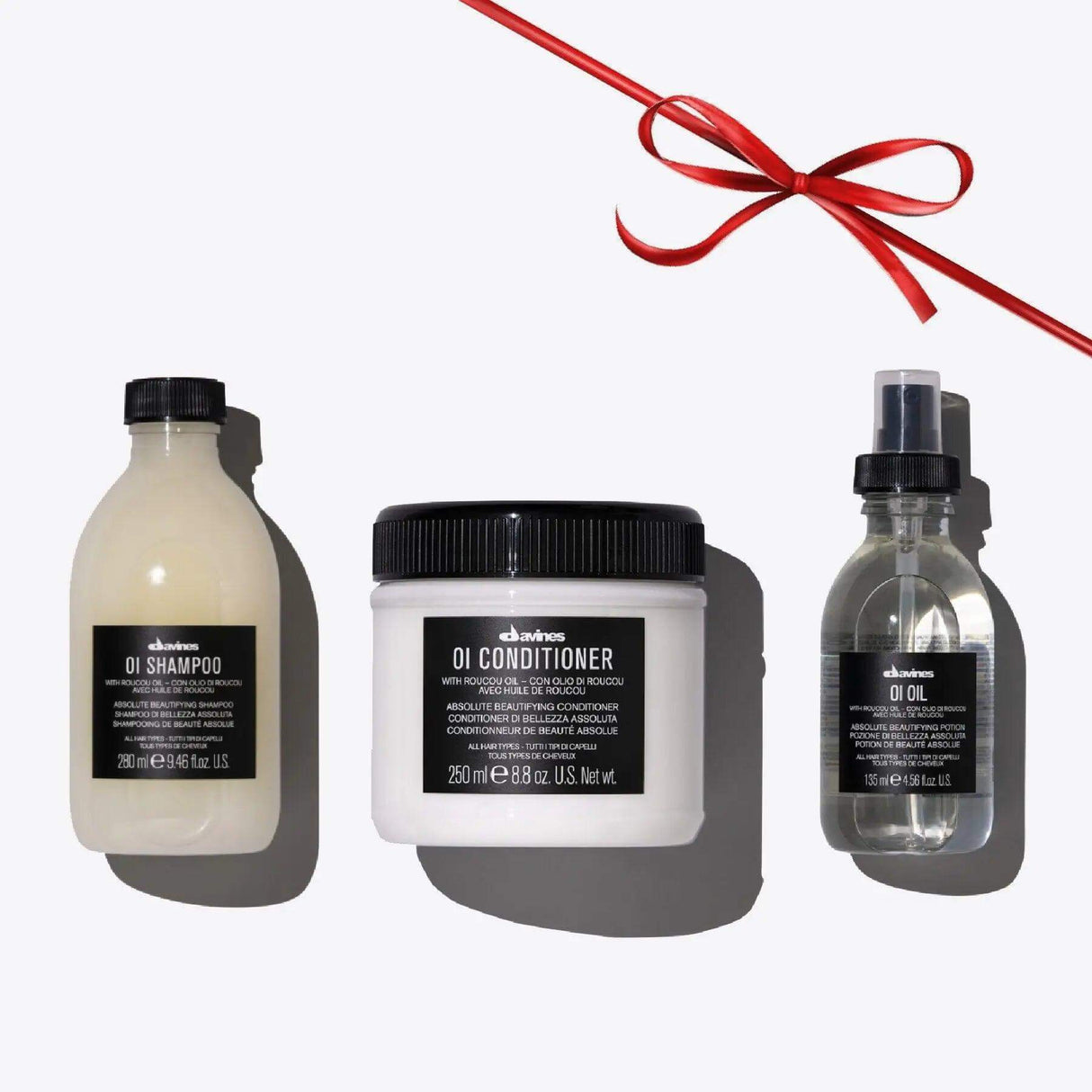 Oi Set featuring shampoo, conditioner, and oil for shiny, aromatic hair; ideal for all hair types with a luxurious fragrance.