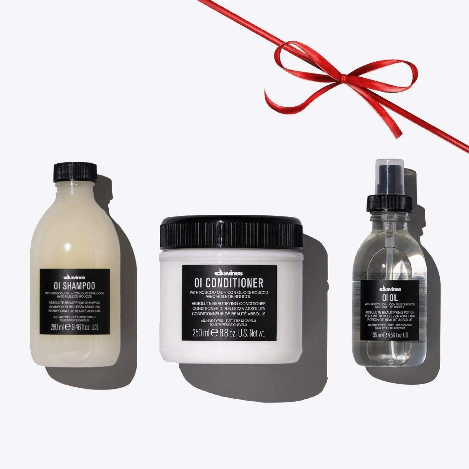 Oi Set featuring shampoo, conditioner, and oil for shiny, aromatic hair; ideal for all hair types with a luxurious fragrance.