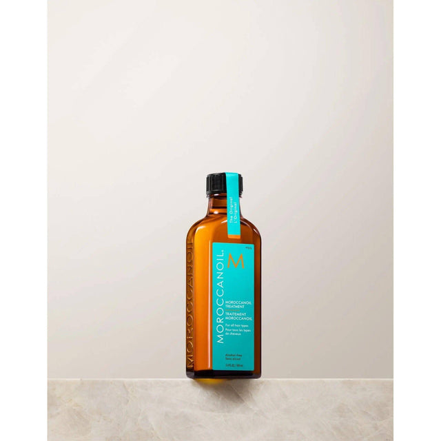 Moroccan Oil Original Hair Treatment bottle with argan oil for silky, smooth hair. Repairs split ends and reduces frizz.