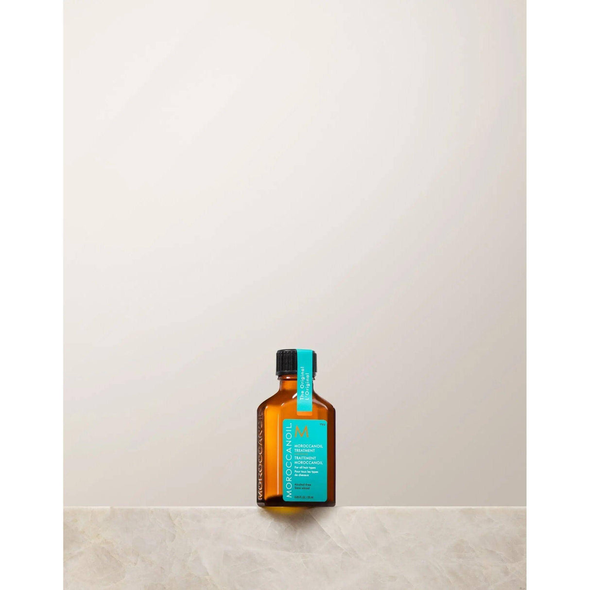 Bottle of Moroccan Oil Original Hair Treatment containing argan oil, ideal for silky, smooth, frizz-free hair and repair of split ends.