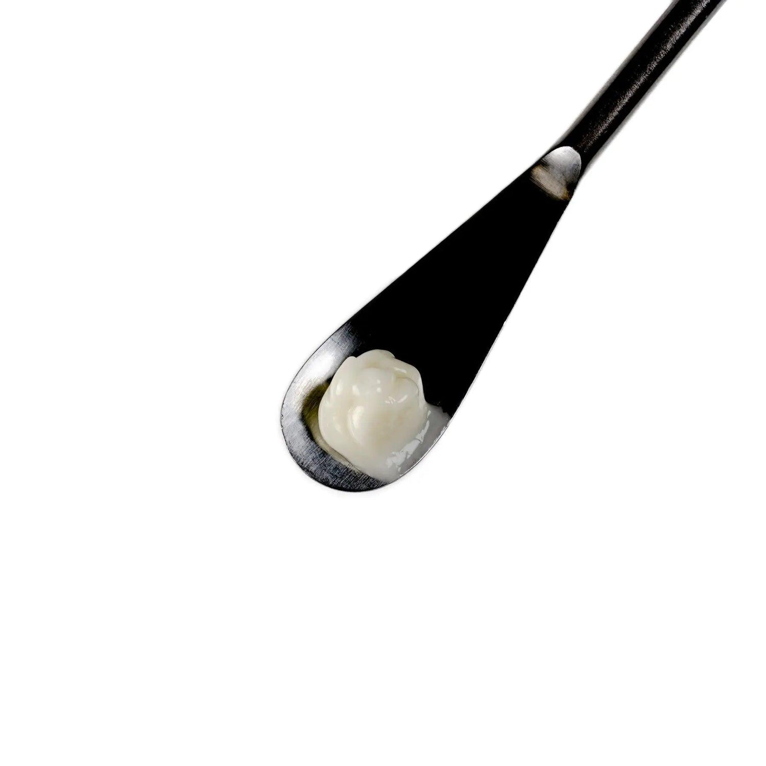 Close-up of Phyto Stem Cell+ Eye Contour Cream on a spatula, showcasing its creamy texture and natural ingredients.