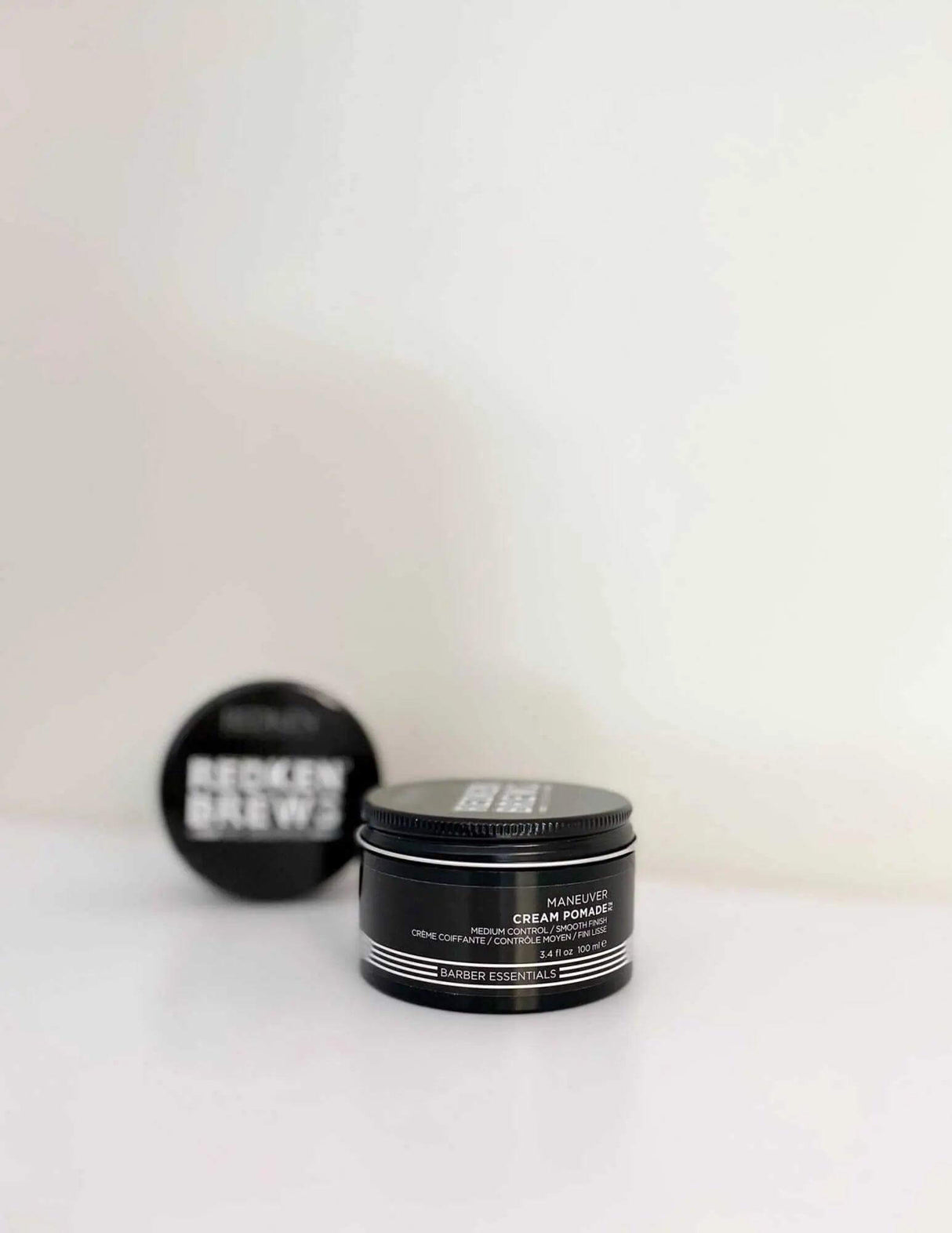 Redken Brews Maneuver Cream Pomade for men's hair styling on white background.