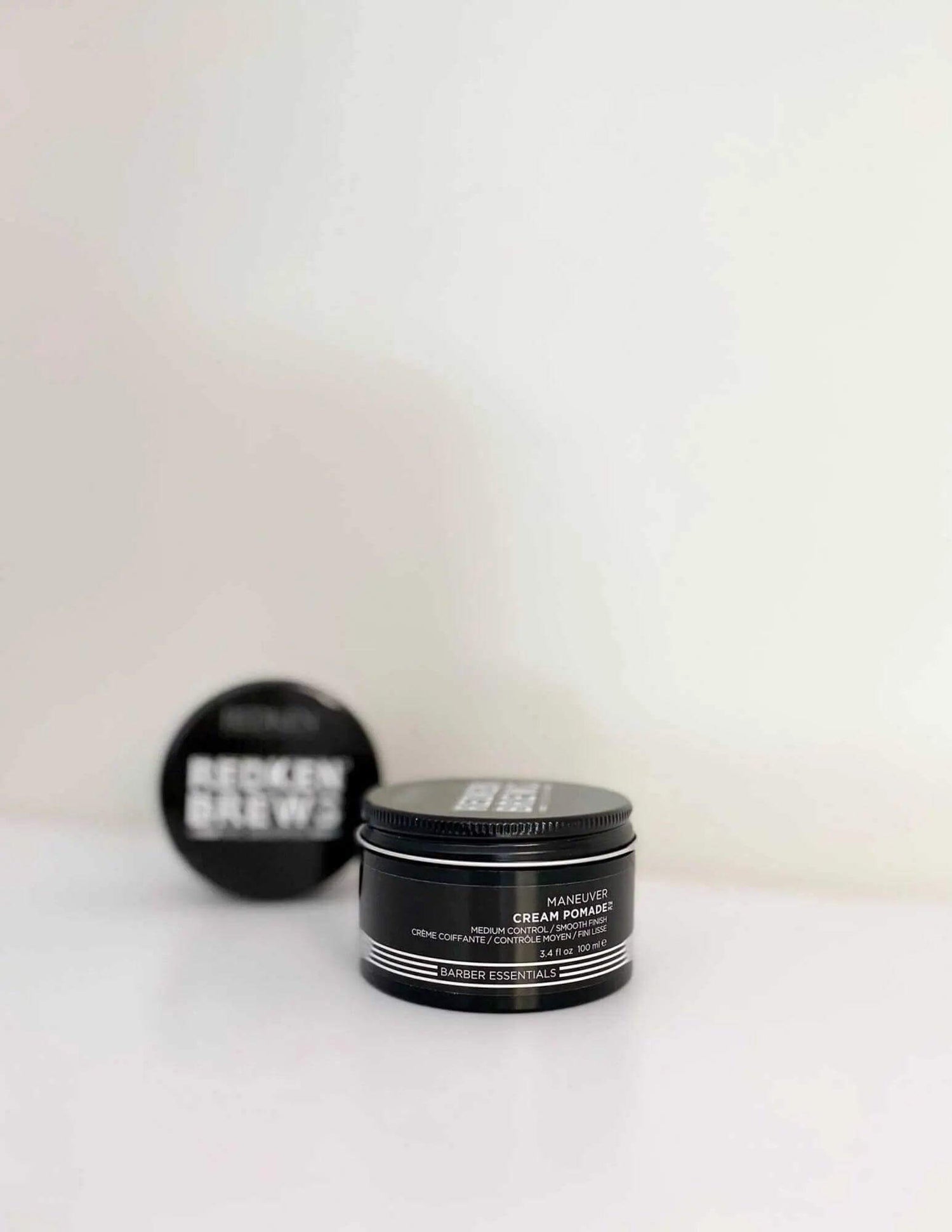 Redken Brews Maneuver Cream Pomade for men's hair styling on white background.