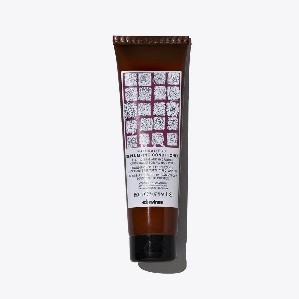 Replumping Conditioner tube designed to moisturize, strengthen, and restore hair elasticity with hydrating active ingredients.