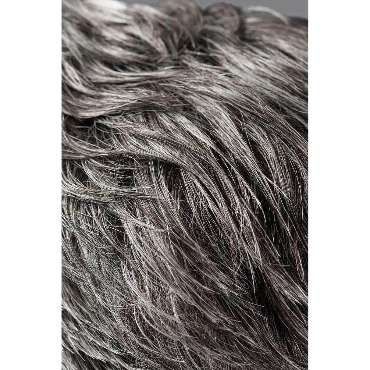 Close-up of textured hair styled with Rough Luxury Soft Molding Paste, showing definition and shine.