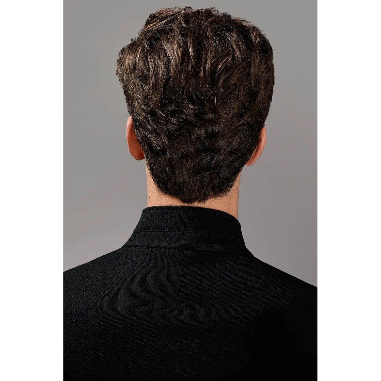 Back view of a man with styled, textured hair showing the effect of soft molding paste.
