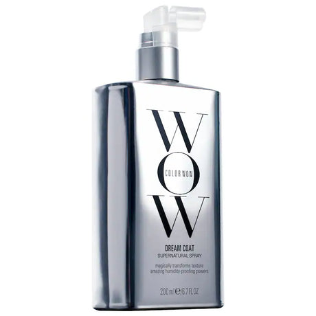 Dream Coat Supernatural Spray bottle for anti-frizz treatment, offering glossy finish and humidity protection for smooth, weightless hair.