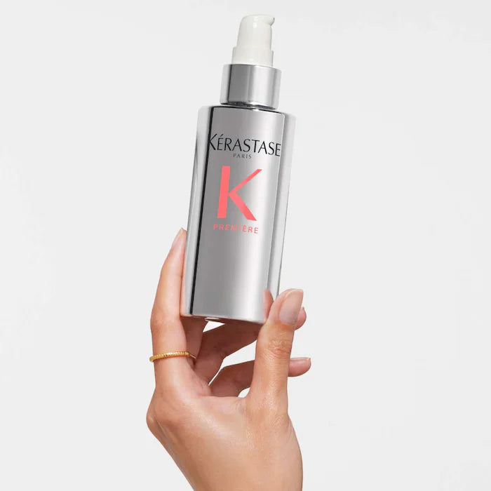 Kérastase Sérum Filler Fondamental bottle held in hand, treatment for damaged hair, provides glossy and supple finish.
