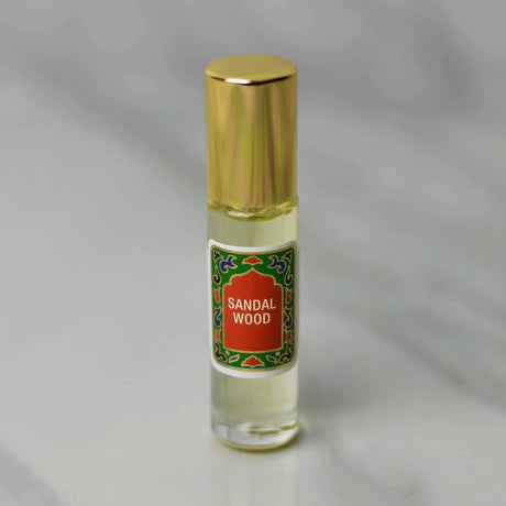 Sandalwood Roll-On Perfume 10ml with gold cap, featuring woodsy and rose aroma, alcohol-free fragrance with sustainable ingredients.