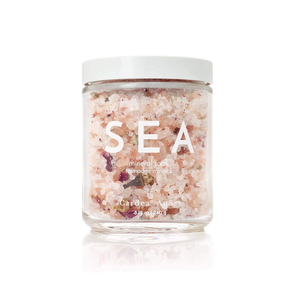 Jar of Sea Mineral Soak with sea salts and rose petals for skincare, relaxation, and stress relief.